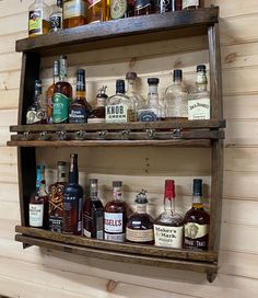 two wooden shelves filled with liquor bottles