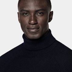 This navy turtleneck sweater is tailored to a slim fit and features a ribbed texture, raglan long sleeves, and ribbed hem and cuffs. Workwear Funnel Neck Sweater With Ribbed Neckline, Funnel Neck Sweater With Ribbed Cuffs For Work, Wool High Neck Sweater With Ribbed Cuffs, Casual Ribbed Collar Turtleneck For Work, Casual Turtleneck With Ribbed Collar For Work, High Neck Merino Wool Sweater With Ribbed Cuffs, Workwear Turtleneck With Ribbed Cuffs, Classic Turtleneck With Ribbed Collar, Classic Funnel Neck Turtleneck With Ribbed Collar