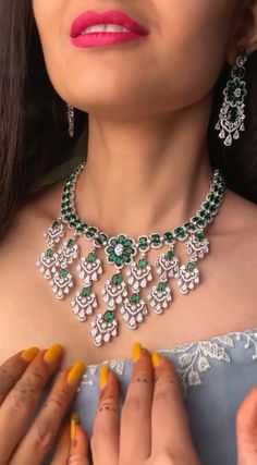 Add a touch of glamour and sophistication with this high quality necklace set in beautiful emerald gree. stones. The stones in this set bling and look close to the real thing. This set is sure to make heads turn!  It features an adjustable necklace and a pair of earrings. It can be paired perfectly with both ethnic and western outfits.  In case of any queries, please feel free to reach out. Happy shopping! Anniversary Emerald Jewelry Set In Round Shape, Exquisite Emerald Bridal Necklace, Emerald Necklace With 17 Jewels For Celebration, Traditional Emerald Jewelry For Party, Fine Jewelry Green Bridal Necklace As Gift, Dazzling Green Diamond Necklaces, Fine Jewelry Emerald Bridal Necklace For Anniversary, Green Emerald Jewelry Sets For Celebrations, Green Gemstone Jewelry Sets For Celebration