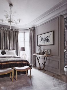 a bedroom with a large bed and chandelier in the corner next to a window