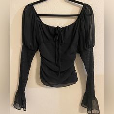 Nwot - Never Worn Ruched Long Sleeve Top With Tie In The Front Side Zipper For Easy Wearing Sleeves Are Somewhat Sheer Size: Xs Color: Black With Silver Metallic Details 95% Polyester Black Ruched Evening Blouse, Fall Gathered Sleeves Top For Night Out, Ruched Party Blouse For Fall, Black Gathered Sleeves Top For Evening, Black Evening Top With Gathered Sleeves, Black Evening Tops With Gathered Sleeves, Fall Evening Blouse With Ruched Details, Fall Evening Ruched Blouse, Fall Party Top With Gathered Sleeves