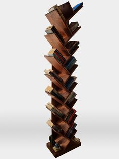 a tall wooden book shelf with many books on it's sides and shelves stacked high