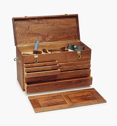 an open wooden box with several compartments