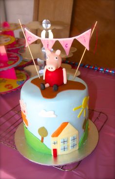 a peppa pig cake sitting on top of a table