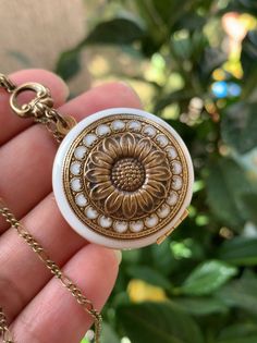 For yourself or someone you love...💕 The sunflower moves itself in the most direct position in front of the sun so it can get the maximum sun rays. This is symbolic of spiritual faith, and worship because we follow our belief system as the sunflower moves to face the life-giving rays of the sun. NOTE: this locket doesn't have photo frames. You can add glue to insert the two photos. ADDING PHOTOS: The option to add photo/photos means that I will be the one who will resize, crop, print, and inser Vintage Gold Jewelry With Sunflower Design, Vintage Birth Flower Medallion Jewelry, Vintage Locket Necklace With Flower Pendant For Gift, White Round Locket Necklace For Keepsake, Vintage Flower Jewelry Keepsake, Vintage Medallion Jewelry With Birth Flower, Vintage Adjustable Sunflower Design Jewelry, Handmade Vintage Locket Necklace Adjustable, Handmade Vintage Adjustable Locket Necklace