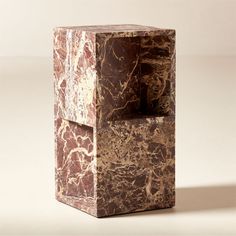 a brown and white marble cube shaped object