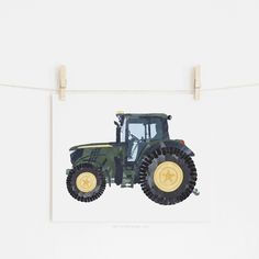 a blue and yellow tractor on a white background with clothes pins hanging from the line