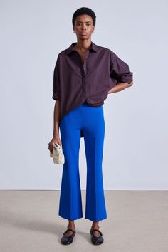 70% Viscose, 30% GRS Recycled Nylon Made in China Elastic waistband, center front and back seam detail, kick flare Dry clean only Inseam: 26 3/4” Size S front rise: 10 1/2" Runs large, we suggest sizing down Model is 5'10 and wearing a size small Modern High Waist Blue Pants, Modern Blue High-waist Pants, Modern Fitted Blue Bottoms, Modern Blue Wide Leg Pants, Modern Wide Leg Blue Pants, Modern Blue Bottoms For Fall, Blue Flare Pants In Elastane, Blue Flare Pants With Elastane, Modern Wide Leg Blue Bottoms