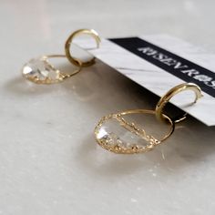 Small brass hoop earrings hold faceted glass pendants encased in gold plated brass Water Earrings, Brass Hoop Earrings, Brass Hoops, Faceted Glass, Jewelry Earrings Hoops, Star Designs, Bridal Earrings, Clear Water, Glass Pendants