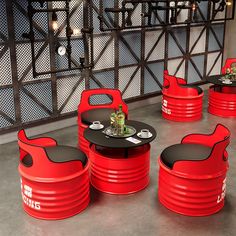 red chairs and tables with black seats in a room