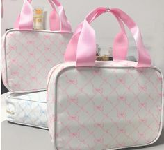 two white and pink bags sitting next to each other