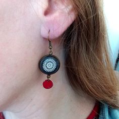 Lovely black Mandala earrings ♥

PLEASE, NOTE THAT THE STANDARD SHIPPING IS WITHOUT TRACKING (99% safe and reliable). YOU CAN CHOOSE A SHIPPING WITH TRACKING AT CHECKOUT.

→ MEASUREMENTS:

• Earrings 16 mm / 0.63" in diameter.
• Length : 50 mm / 1.97" in diameter

→ MATERIALS:

• High-quality picture is printed on waterproof paper and protected with a glass cabochon 
• All findings are Nickel Free. (zinc alloy)

→ PACKAGING:

• These earrings will be shipped in a gift box, ready for giving (or k Black Retro Handmade Jewelry, Retro Black Handmade Jewelry, Black Enamel Earrings, Pierced, Black Enamel Dangle Earrings For Gift, Gift Black Enamel Dangle Earrings, Black Enamel Pierced Earrings, Red Round Jewelry With Black Enamel, Handmade Black Enamel Earrings, Black Enamel Nickel-free Earrings