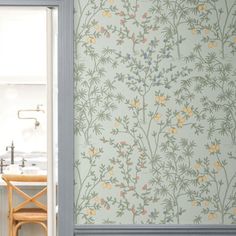 the wallpaper in this kitchen looks like it has been painted with flowers and leaves