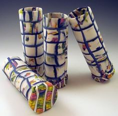 three vases with different designs on them sitting next to each other in front of a gray background