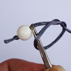 a pair of scissors that are being used to tie something