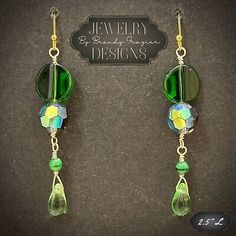 pair of green and yellow earrings with dangling glass beads on hooks or earwires