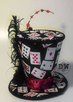 a top hat decorated with playing cards and feathers