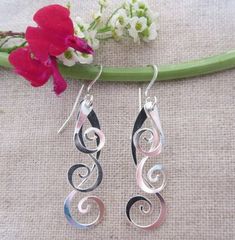 Curlicue Drops Modern Twist Silver Teardrop Jewelry, Teardrop Earrings With A Modern Twist As A Gift, Modern Twist Teardrop Earrings Gift, Hand Forged Spiral Jewelry Gift, Modern Twist Dangle Jewelry For Gifts, Elegant Artistic Drop Earrings Jewelry, Wire Wrapped Spiral Jewelry, Sterling Silver Teardrop Jewelry With Artistic Design, Silver Teardrop Earrings With Artistic Design