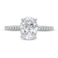 an oval cut diamond ring with pave set shoulders