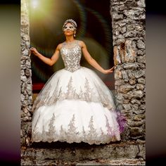 a woman in a wedding dress standing outside