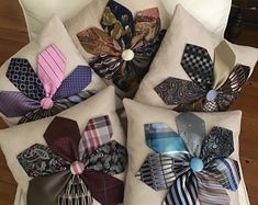 several different types of ties are arranged on pillows