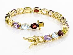 4.68ctw oval red garnet with 3.19ctw oval yellow citrine, 4.25ctw oval blue topaz, 3.19ctw oval amethyst and 2.55ctw oval peridot 18k yellow gold over sterling silver line bracelet. Measures approximately 0.20"W. Box clasp with double safety closure. Gold Oval Bracelet With Gemstone Accents, Oval Gold Bracelet With Gemstone Accents, Gold Oval Bracelets With Gemstone Accents, Oval Gold Bracelets With Gemstone Accents, Oval Gold Gemstones With Accents, Multi Gemstone Bracelet, Improve Confidence, Mother Daughter Gifts, Silver Line