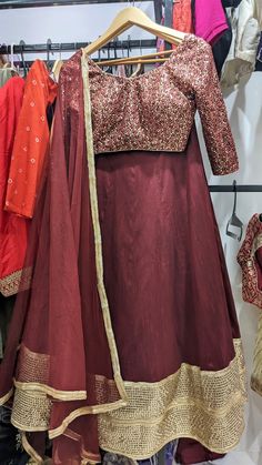 Maroon & Gold color Lehenga set for women! This outfit can Be made in ANY COLOR. Please send us a convo if you want this in a different color.  Blouse: Heavy thread and sequins work on net Lehenga: Art Raw Silk Dupatta: Soft Net   MEAUREMENTS & CUSTOMIZATIONS   For custom sizing please include the below measurements in the the notes.  * Chest size: * Waist size: * Blouse Length: * Bicep: * Arm-hole: * Sleeve Length: * Front Neck Depth: * Back-Neck Depth: * Skirt Waist: * Skirt Length:   SHIPPING & HANDLING   Since all our orders are custom made, we require 1-3 weeks of processing time.  Please leave your contact number in notes section while placing the order OR message us later. The shipping companies need your contact number incase they need to contact you during delivery.  Our shop is b Embroidered Long Lehenga For Diwali, Long Embroidered Lehenga For Diwali, Diwali Embroidered Long Lehenga, Fitted Sets For Festive Occasions, Fitted Festive Sets For Festivals, Anarkali Floor-length Choli For Traditional Ceremonies, Long Semi-stitched Choli For Diwali, Festival Art Silk Anarkali Set, Art Silk Saree Sets For Festival