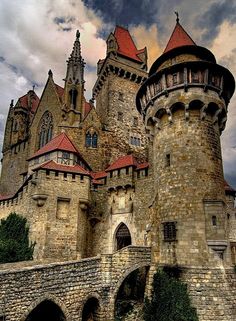 the castle is built on top of an old stone wall and has red roof tops