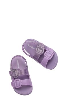 Your youngster will be ready for fun in the sun with this slingback sandal featuring buckled straps and a signature scent. Adjustable slingback strap with hook-and-loop closure Water-resistant MELFLEX™ PVC is durable, flexible, hypoallergenic and recyclable Synthetic upper/unlined/synthetic sole Made in Brazil Trendy Adjustable Slingback Sandals With Buckle, Adjustable Glitter Casual Sandals, Adjustable Glitter Sandals For Summer, Casual Adjustable Glitter Sandals, Adjustable Jelly Sandals With Buckle Closure, Synthetic Sandals With Buckle Closure, Summer Adjustable Glitter Sandals, Purple Non-slip Slide Sandals, Mini Melissa