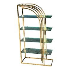 a gold and green shelf with glass shelves