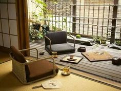 a room with two chairs and some plates on the floor next to each other in front of a sliding glass door