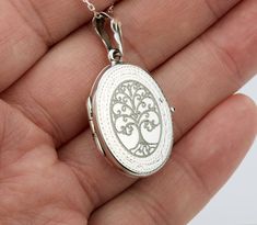 "Also available in gold plated/rose gold plated over sterling silver. This elegant customized oval locket will help you keep the memories of your loved ones afresh: 1. One shining, highly polished sterling silver locket. (19 x 26 mm, about the size of a quarter, 4.6 grams). Its front has an etched decorative border. Its back is plain. Both sides can be custom engraved with initial, text or simple graphics.  2. There are two photo slots. Photo insertion service is available for $14 each photo (pricing reflected in your pulldown option. If you select \" ... 1/2 photo\", please send your locket photos by attaching them to an ETSY conversation to me. 3. a sterling silver or gold filled cross pendant     Upgrade is also available:     https://www.etsy.com/listing/736367470 4. an optional custom White Gold Medallion Locket Necklace As Gift, Rose Gold Oval Pendant Locket Jewelry, Classic Nickel Free Locket Necklace For Gift, Classic Nickel-free Locket Necklace As Gift, Classic Nickel-free Locket Necklace Gift, Classic Locket Necklace With Charms For Gift, Heirloom Engraved Jewelry For Anniversary, Heirloom Oval Jewelry For Gifts, Oval White Gold Locket Necklace For Wedding