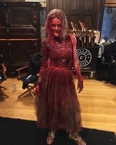 a woman dressed as a zombie in a red dress