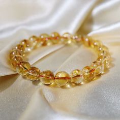 This beautiful 9mm Rainbow Citrine bracelet is the perfect gift to spark joy and beauty in someone's life. It is made from the highest quality crystal and is perfect for home decor, healing crystal, and gifting. The soft rainbow hues of this Rainbow Citrine bracelet will take your breath away. The iridescent tones of this lovely crystal warmly embrace you and make you feel secure in knowing that life has a plan for you that will be infinitely beautiful. Not only does it bring peace to your soul, but it also radiates amazing energies far beyond what you can see, allowing its healing properties to protect your physical, emotional, and spiritual wellbeing. Rainbow Citrine is known as one of the most powerful crystals of abundance and prosperity. It encourages you to manifest your ideal realit Luxury Yellow Gemstone Bracelet, Amber Gemstone Beads Crystal Bracelet As Gift, Amber Crystal Bracelet With Gemstone Beads As Gift, Amber Round Bracelets As A Gift, Amber Round Bracelets As Gifts, Round Amber Bracelet As Gift, Round Amber Bracelet Gift, Amber Crystal Bracelet With 8mm Beads As Gift, Elegant Amber Crystal Bracelet For Healing