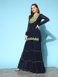 Navy blue yoke design Kurti with Sharara with dupattaFloral yoke designA-line shapeRegular styleRound neck, long regular sleevesThread work detailAbove knee length with straight hemPoly georgette machine weave fabricSolid ShararaPartially elasticated waistbandSlip-on closure Thread Work Kurti, Kurti With Sharara, Design Kurti, Yoke Design, Navy Blue Art, Lehenga Blouse, Pink Art, Thread Work, Green Silk