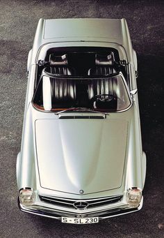 an overhead view of a silver car with its hood up