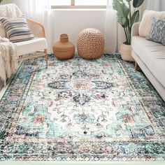 a living room area with couches and rugs