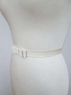 This elegant simple bridal belt is beautifully made in silk Duchess satin. This belt features an elegant bow in the front and it is finished with the matching buttons and hand crochet loops in the back. This belt measures 1 wide and the length is finished to your measurements. Available in a variety of colors. * Please include your waist measurements in the notes during checkout and your belt will be finished at that length - For the photos of the color choices please take a look at the li... Formal Sashes With Matching Belt, Elegant Fitted Belts And Suspenders With Matching Belt, Adjustable Formal Sash Belt, Elegant Adjustable Sash For Formal Occasions, Elegant Adjustable Sashes For Formal Occasions, Elegant Formal Adjustable Sash, Elegant Formal Adjustable Sashes, Formal Adjustable Bridal Belt With Sashes, Elegant Ribbon Bridal Belt For Wedding