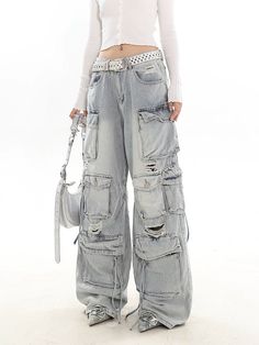 Experience the ultimate blend of streetwise flair and classic comfort with our Distressed Wide-Leg Denim Cargo Pants.Made with premium denim, these pants boast a relaxed wide-leg fit and a natural waist design, providing a comfortable experience without compromising on style. The distressed details and multiple pockets echo a laid-back vibe while adding practicality and edge to your look. These versatile pants serve as the perfect canvas for a variety of styling options – pair them with a sleek Casual Wide-leg Jeans With Belt Loops, Y2k Wide Leg Flare Jeans With Pockets, Y2k Style Wide Leg Flare Jeans With Pockets, Y2k Wide Leg Cargo Jeans, Denim Blue Wide Leg Y2k Cargo Jeans, Distressed Wide Leg Cargo Jeans For Fall, Y2k Wide Leg Medium Wash Cargo Jeans, Y2k Wide Leg Cargo Jeans Medium Wash, Y2k Style Wide Leg Medium Wash Cargo Jeans