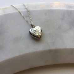 Vintage silver heart pendant on chain.This vintage silver heart shaped pendant features engraving on the front with a plain back. There are also the initials 'FJW' engraved on the top corner of the pendant. There is a small dent near the edge on the back (see photograph). Comes on a modern sterling silver 18" chain or with no chain, please select which from the dropdown box.Marked 'SILVER' on the reverse.Locket measures 1.5cm wide, 1.6cm high, 0.5cm deep.The necklace will come beautifully presen Star Charm Necklace, Heart Shaped Pendant, Engraved Pendant, Silver Heart Pendant, Funky Jewelry, Vermeil Jewelry, Silver Lockets, Heart Shape Pendant, Charm Rings