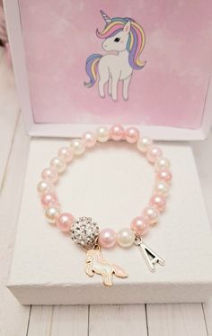 This beautiful Unicorn Charm bracelets is the perfect gift for someone special. The bracelet is made of high-quality beads. This makes an excellent gift for yourself or your friends and family members.  The bracelet is made with a high-quality beads. Product Details: - Material: stretchy string,pink and white 8 mm pearl beads, Unicorn and 10mm rhinestone crystal bead. Product Details Length:  Toddler- 5.5 inches S- 6.5 inches M- 7 inches L- 7.5 inches Xl- 8 inches.  Please reach out to me for cu Pink Beaded Bracelets For Birthday, Pink Bracelet Jewelry For Birthday, Cute Beaded Bracelets With Charms For Gift, Pink Bracelets For Birthday Gift, Personalized Pink Pearl Bracelet For Birthday, Pink Beaded Jewelry Birthday Gift, Pink Beaded Jewelry For Birthday Gift, Hypoallergenic Pearl Bracelet For Birthday, Cute Charm Bracelet With Round Beads For Gifts