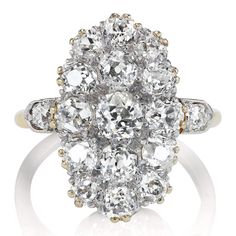 an old cut diamond cluster ring, with two tone gold and white diamonds in the center