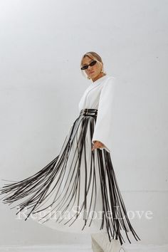 Step into the world of bohemian chic with our stunning Belt with Fringe. This fashion-forward accessory is the perfect addition to elevate your dress, accentuate your waist, and make a bold fashion statement. Crafted with care and attention to detail, this fringe belt exudes a sense of effortless style and adds a touch of flair to any outfit. Choose from an array of captivating colors to match your personal style and wardrobe. From classic black and timeless brown to vibrant red, feminine pink, Blue Fringe Belt, Spring Skirt With Beaded Fringe, Fall Festival Fringe Skirt, Chic Fringe Mini Skirt, Elegant Party Skirt With Tassels, Chic Fringe Skirt For Fall, Chic Festival Skirt, Elegant Fringe Skirt For Evening, Spring Evening Skirt With Fringe Details