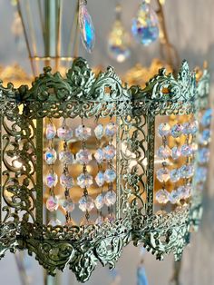 an ornate chandelier hanging from a ceiling in a room with many crystal beads