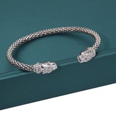 Feel inspired and unique with this one-of-a-kind exotic style on your wrist. Designed in Italy, this new collection has true attention to every detail. Each bracelet is polished by hand and is bright like white gold. The stones sparkle, sitting neatly on the jaguars head and collar. A perfect gift for men and women. ---------- Details ---------- Made from .925 sterling silver Comes in a royal gift box ready to be presented Ships within 24 hours. Free first class shipping + free returns. -------- Adjustable Diamond Accented Cuff Bangle, Adjustable Bangle Cuff Bracelet With Diamond Accents, Adjustable Diamond-accent Cuff Bangle, Luxury Silver Adjustable Cuff Bracelet, Silver Cuff Bracelet With Diamond Accents As Gift, Adjustable Round Cuff Bracelet With Cubic Zirconia, Adjustable Silver Cuff Bracelet With Diamond Accents, Modern Silver Cuff Bracelet With Diamond Accents, Adjustable Cubic Zirconia Cuff Bangle Bracelet