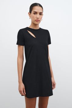 You could live in Leonie, the black t-shirt dress inspired by our best-selling Leonie Tee. Her European organic cotton jersey fabric and relaxed fit make her the perfectly comfortable day-to-night staple. But Leonie's geometrically chic front cutout and cropped length also deliver personality and edge to your everyday. This black cutout dress offers short sleeves and a crew neckline.[SPLIT] Astrid is 5'9" (175 cm) tall, wearing size XS. Total length is approximately 33" (84.5 cm). French Organic Black T-shirt Dress For Loungewear, Trendy Black Dress For Loungewear, Trendy Black Loungewear Dress, Trendy Black Lounge Dress, Casual Mini Dress With Cutout And Short Sleeves, Chic Cotton T-shirt Dress, Modern Black Cotton Dresses, Style A T Shirt, Black Cutout Dress