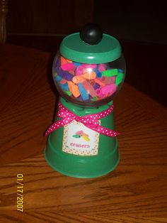 a gummy machine filled with lots of colorful candies on top of a wooden table