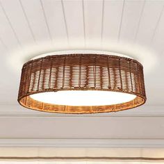 a wicker light fixture hanging from the ceiling