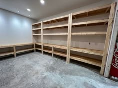 an empty room with shelves and coca - cola machines in it's storage area