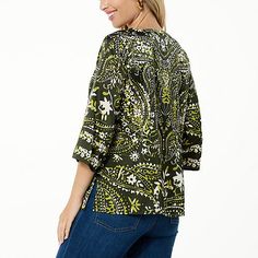 Colleen Lopez Woven Relaxed Fit Printed Top  This easy-breezy woven top features an amazing print that's sure to complement your style. It perfectly pairs with just about any pant, legging or skirt. Patterned Abstract Print V-neck Top, Green V-neck Top With Vibrant Print, Green Graphic Print Blouse With Relaxed Fit, Green Blouse With Graphic Print And Relaxed Fit, Green Relaxed Fit Blouse With Graphic Print, Relaxed Fit Green Blouse With Graphic Print, Green Printed Crew Neck Blouse, Green Graphic Print Blouse For Spring, Green Fall Vacation Tops